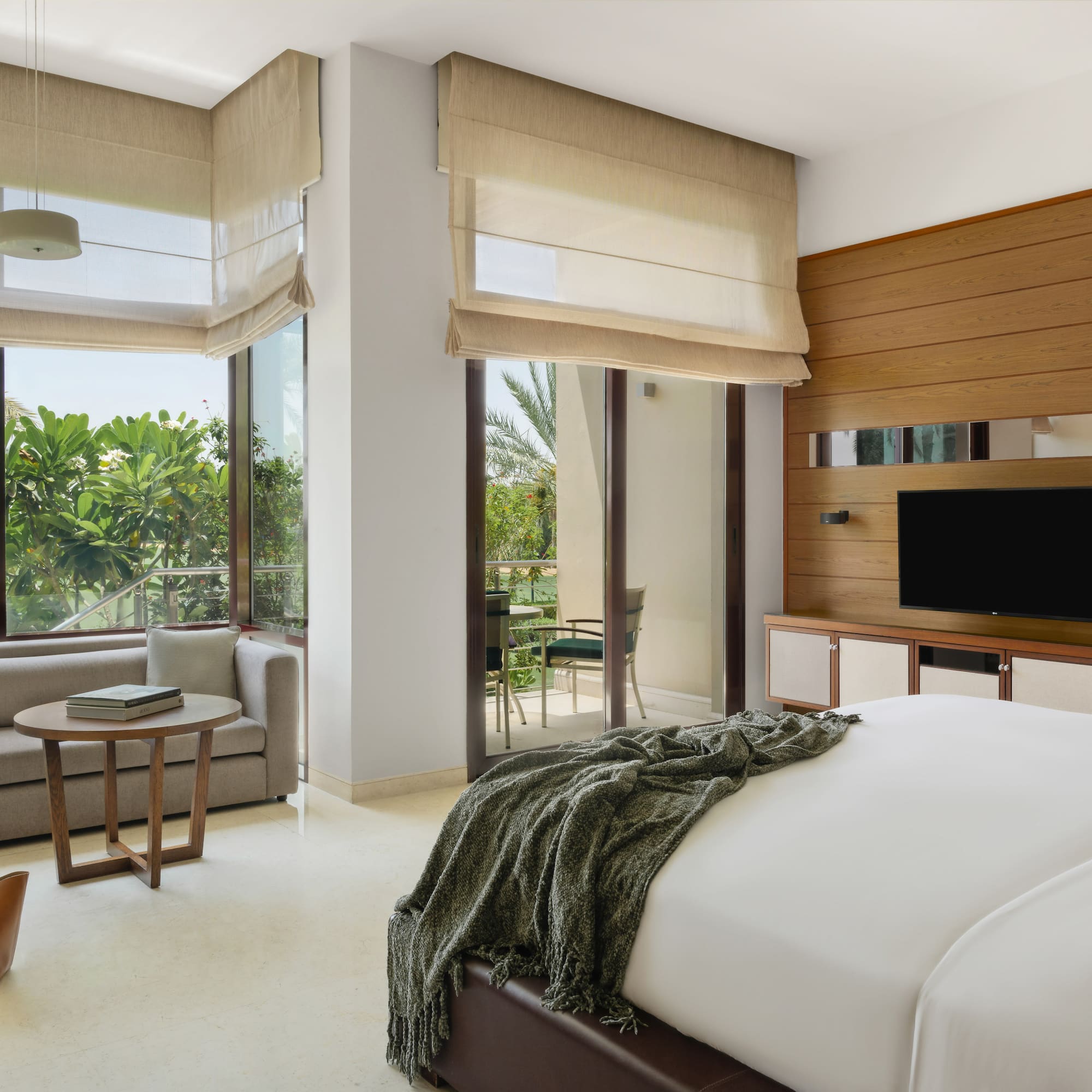 a bedroom with a television and a bed