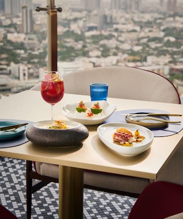 a table with plates of food and a drink on it