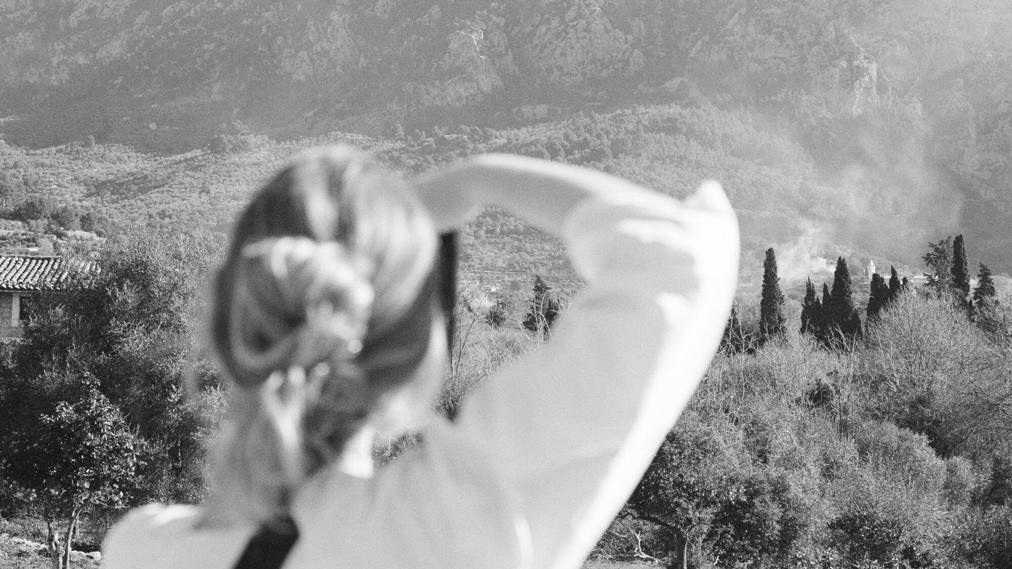 a woman looking at a mountain