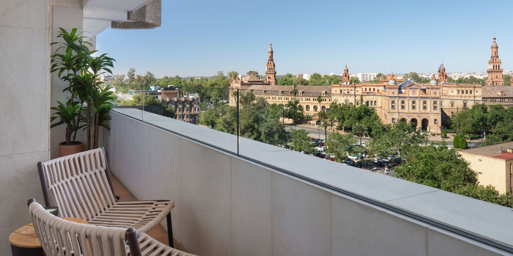 a balcony with chairs and trees
