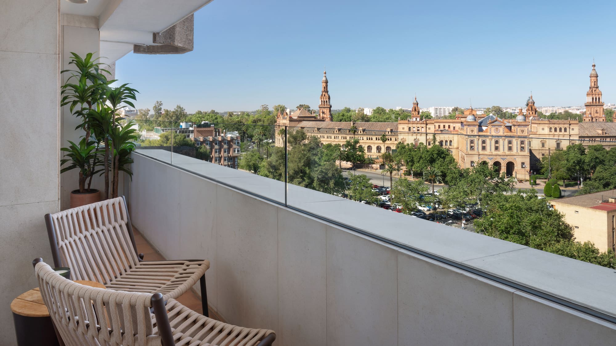 a balcony with chairs and trees