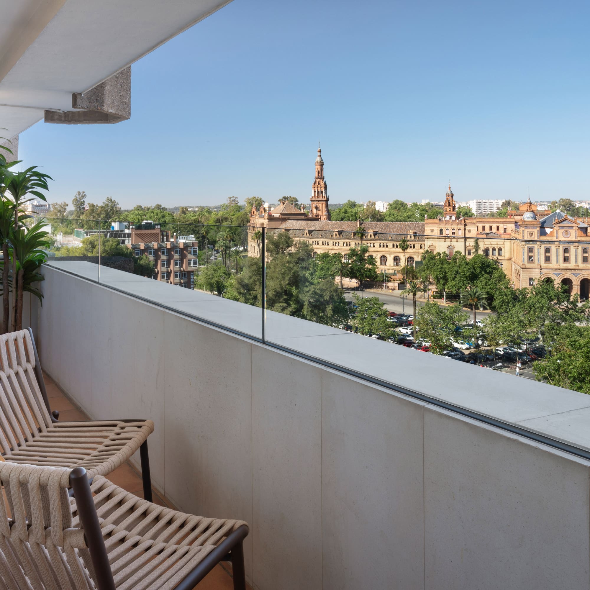 a balcony with chairs and trees