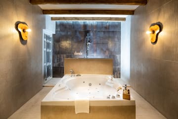 a large white bathtub in a bathroom