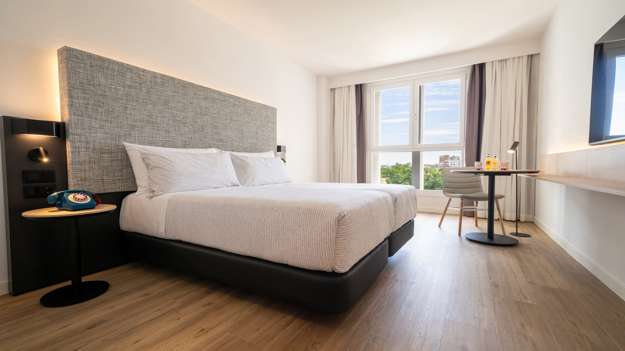 a bedroom with a bed and a table