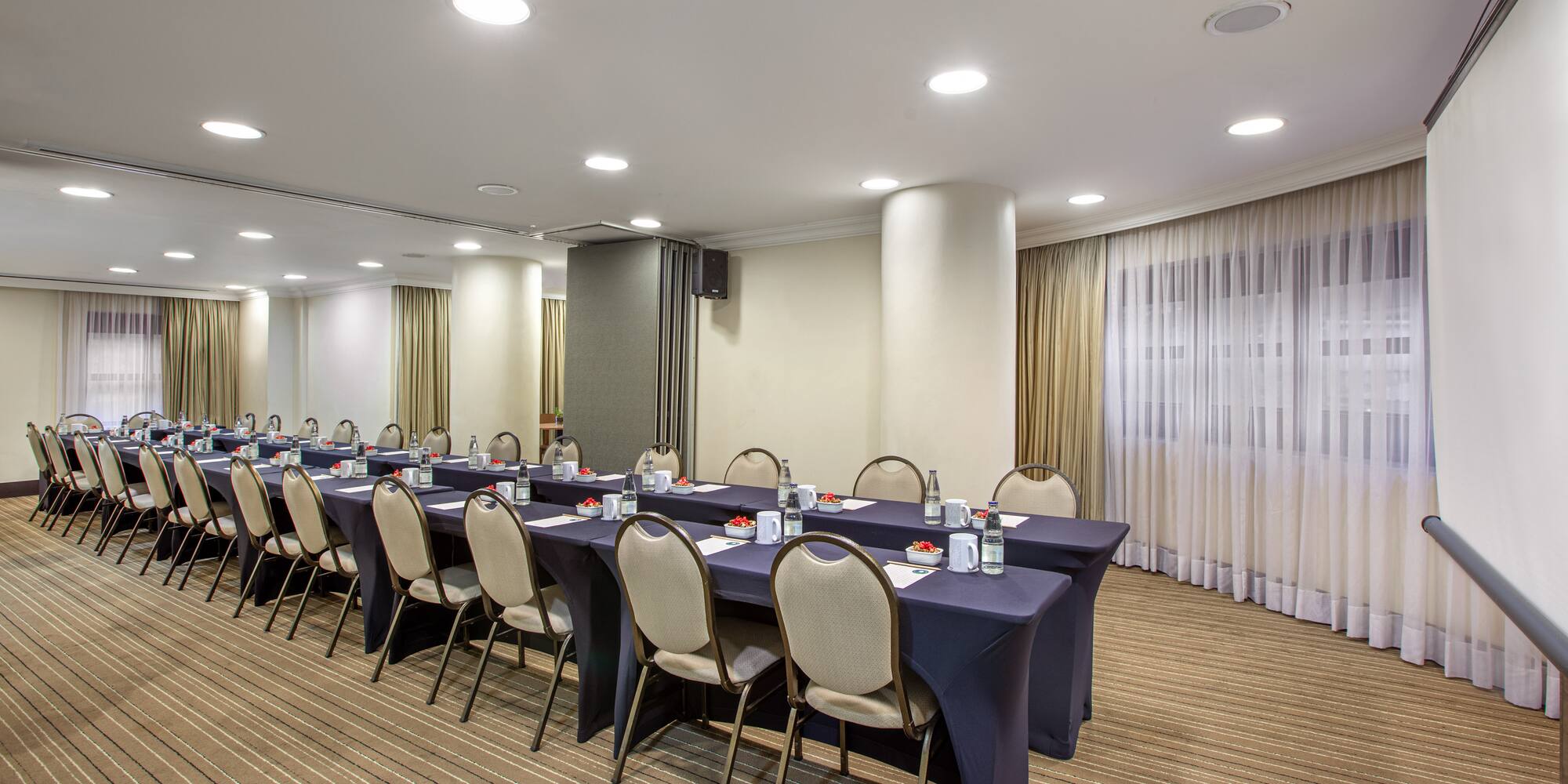 a room with long tables and chairs