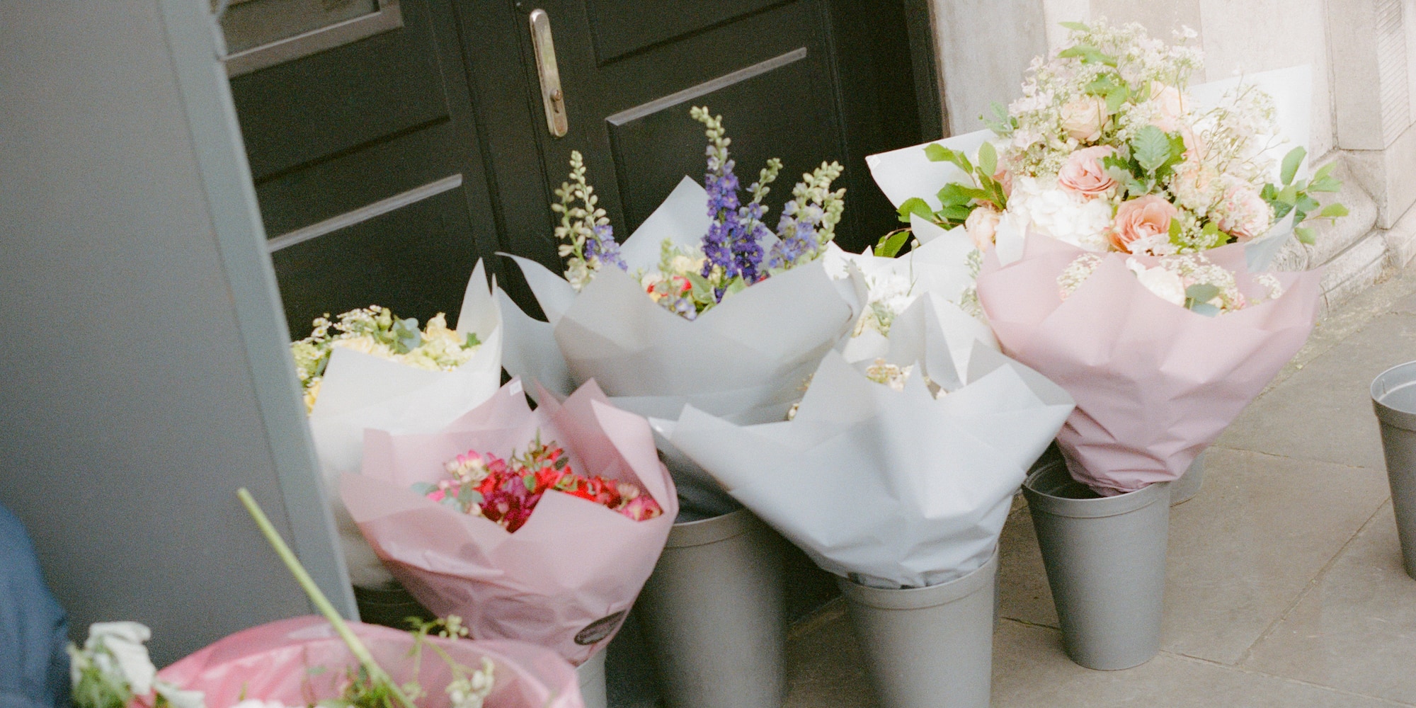 a group of buckets of flowers