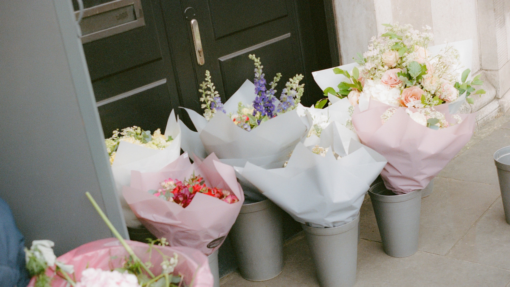 a group of buckets of flowers