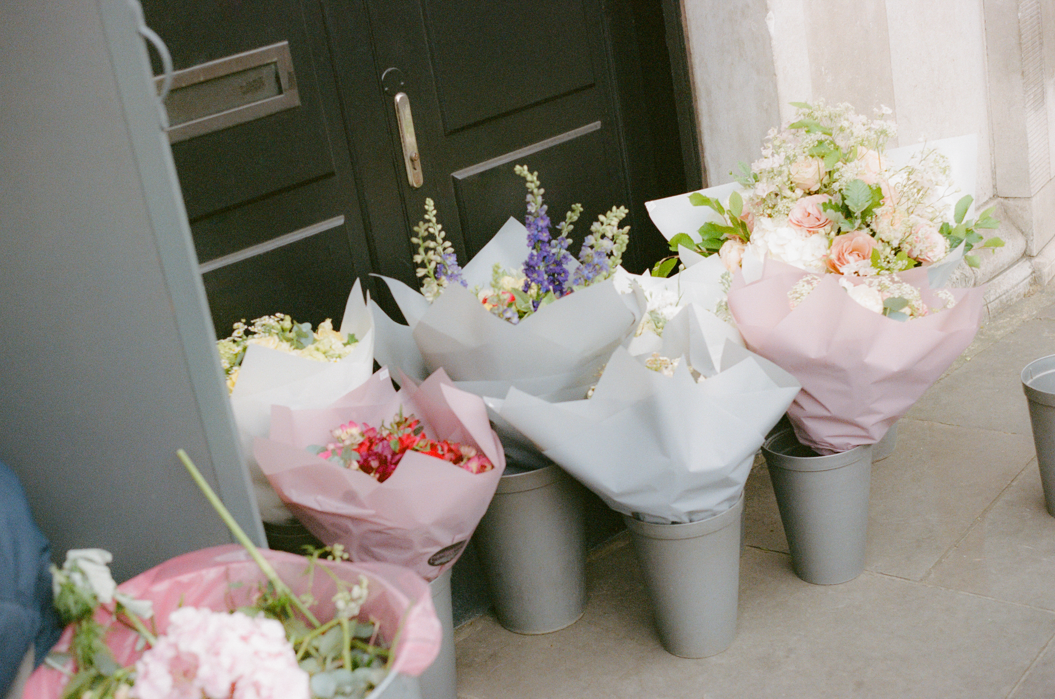 a group of buckets of flowers