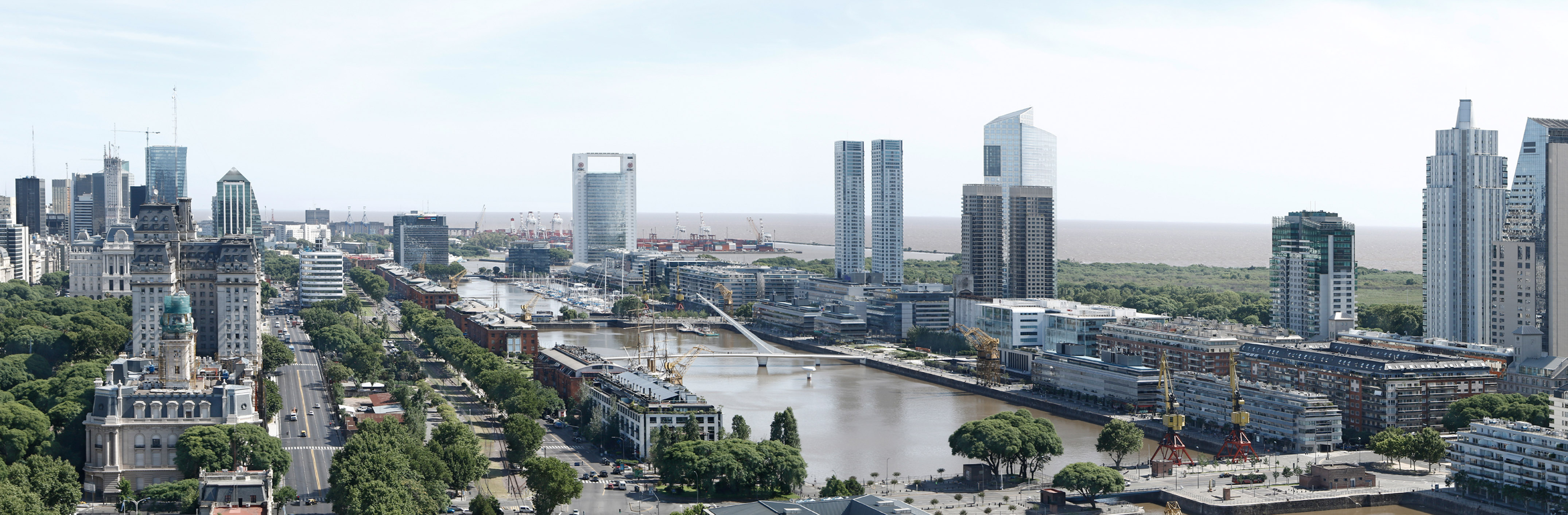 Buenos Aires, Puerto Madero skyline with river, modern towers, historic buildings.