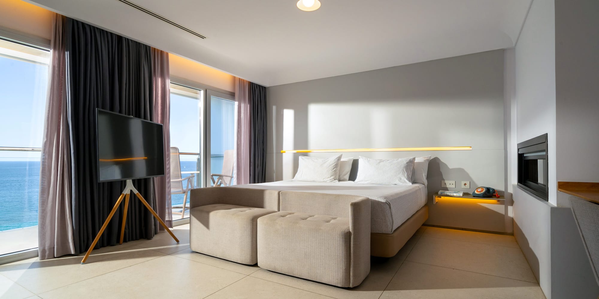 a room with a bed and a television