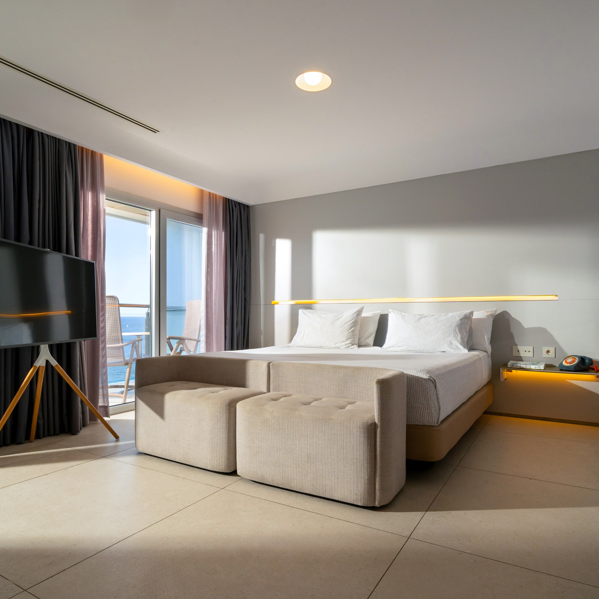 a room with a bed and a television