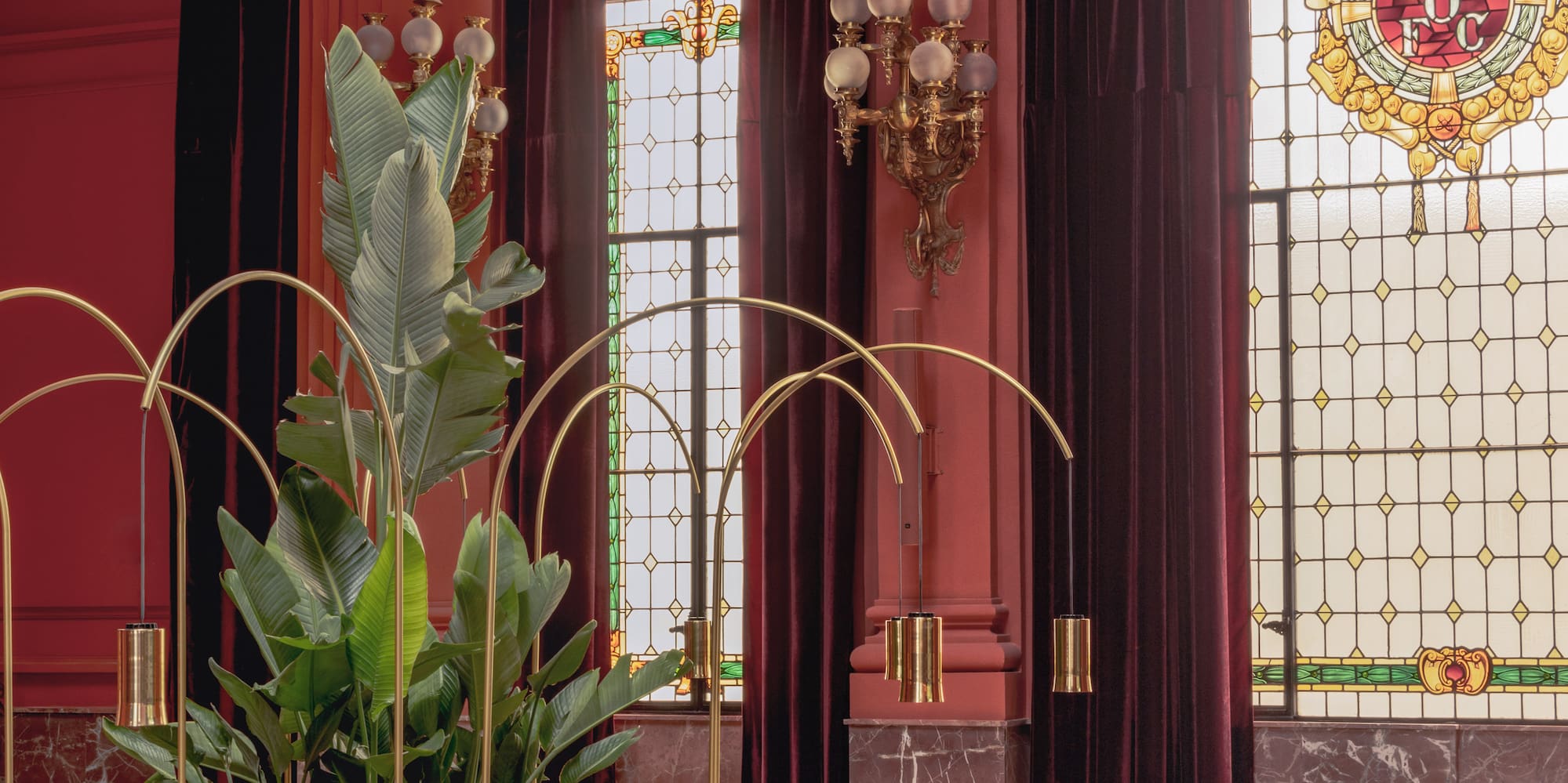 a room with a large window and a plant