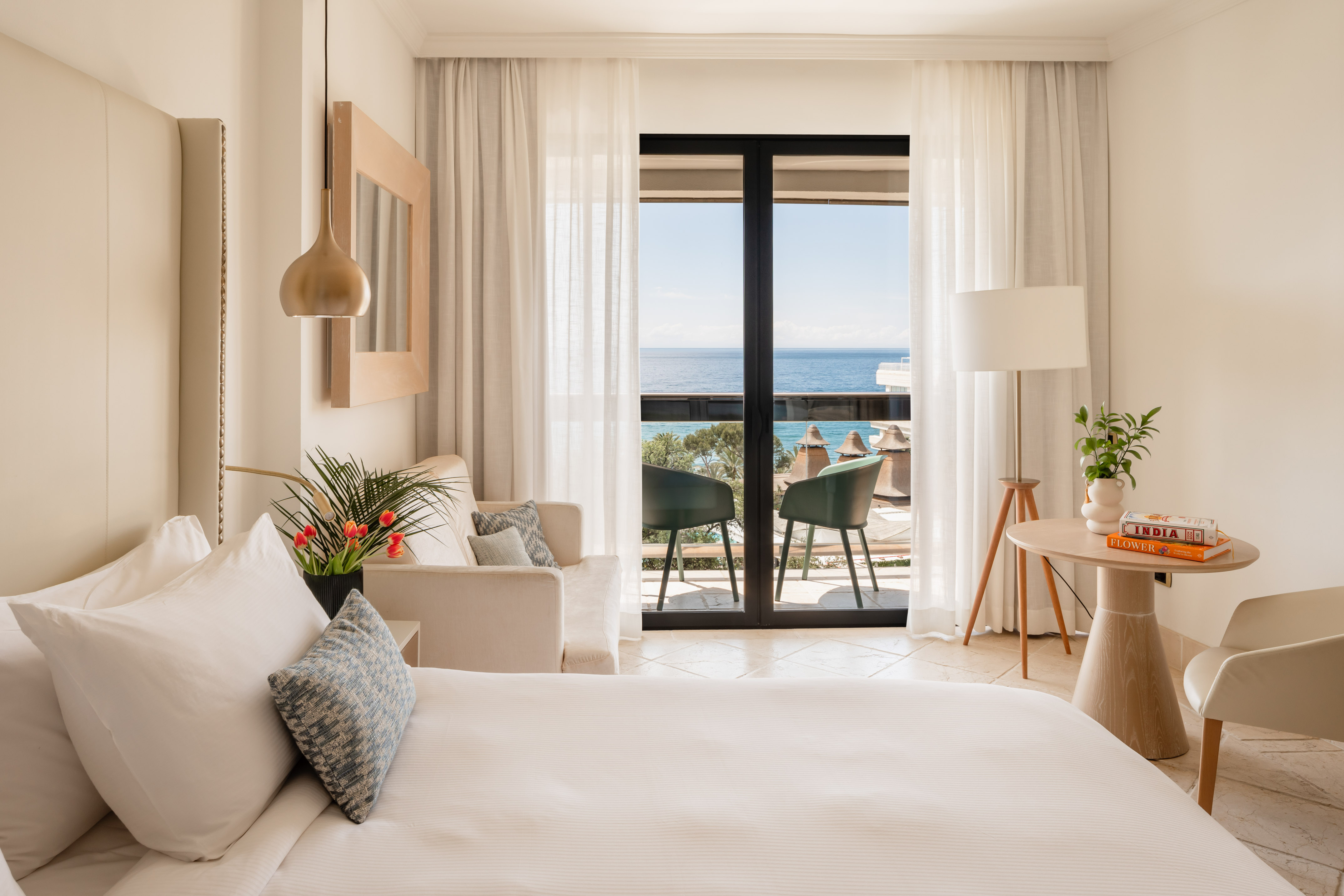 a bedroom with a bed and a couch and a table