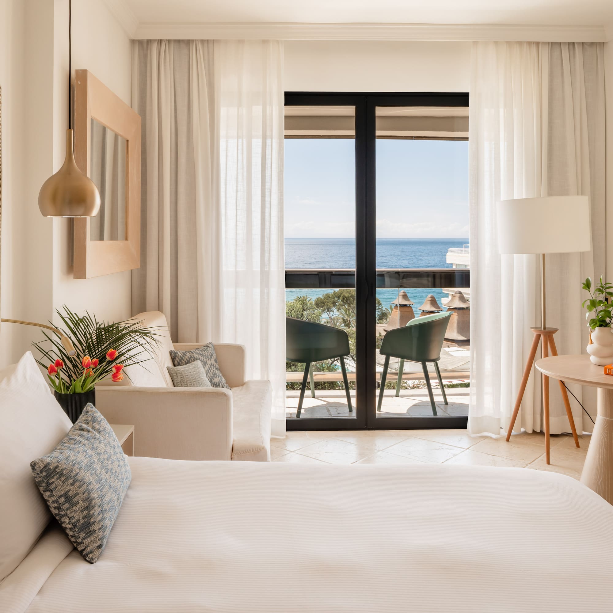 a bedroom with a bed and a couch and a table