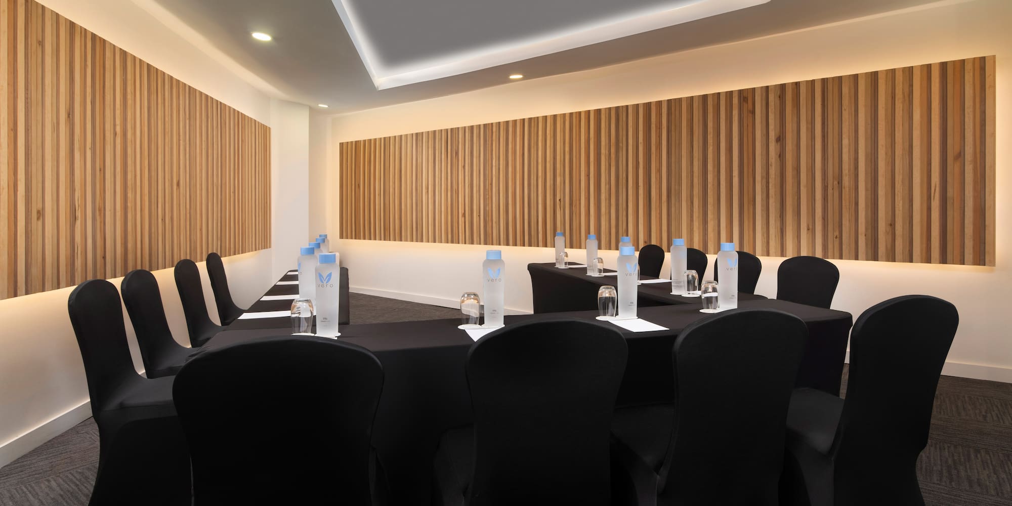 a room with black chairs and tables