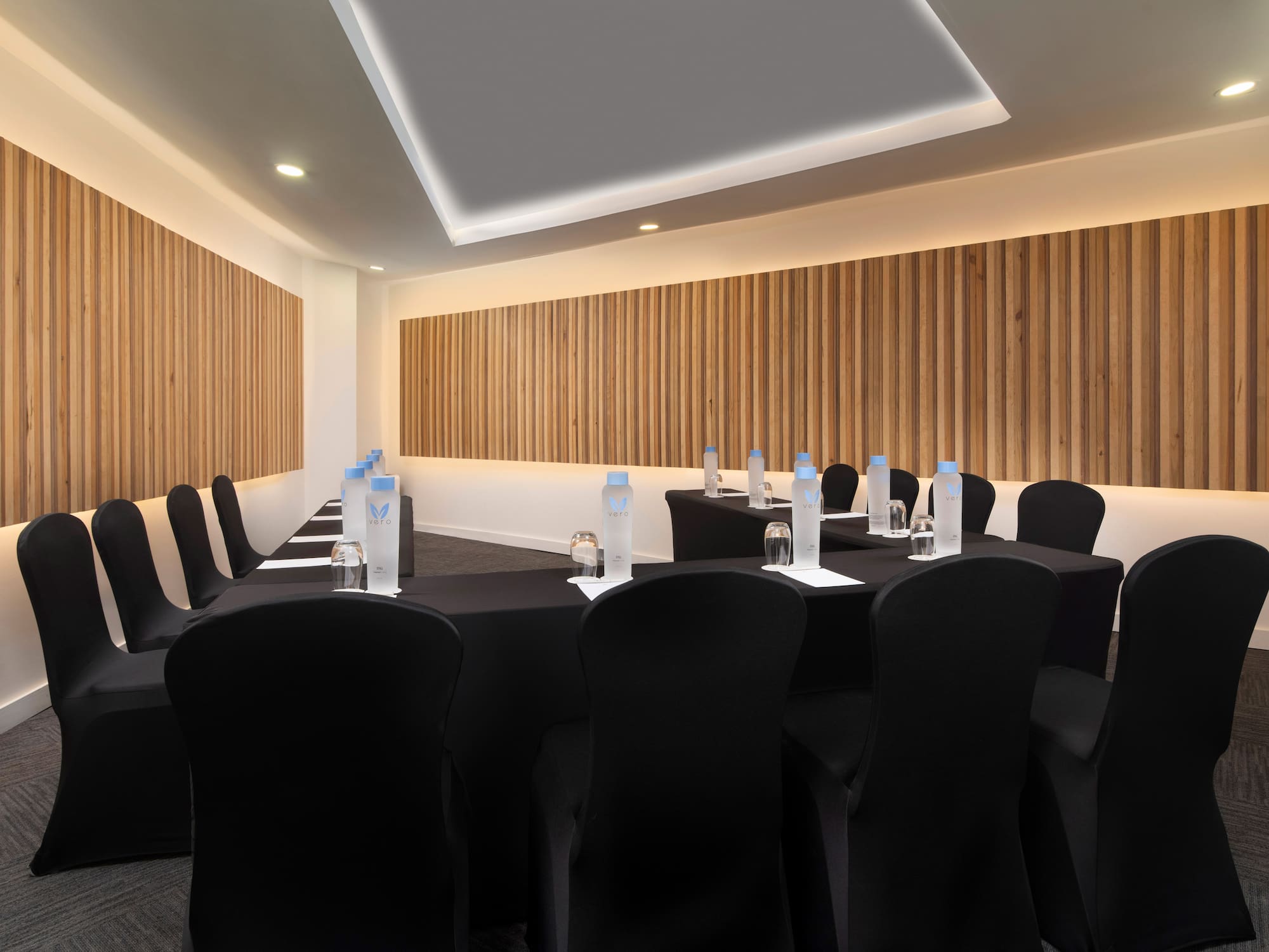 a room with black chairs and tables