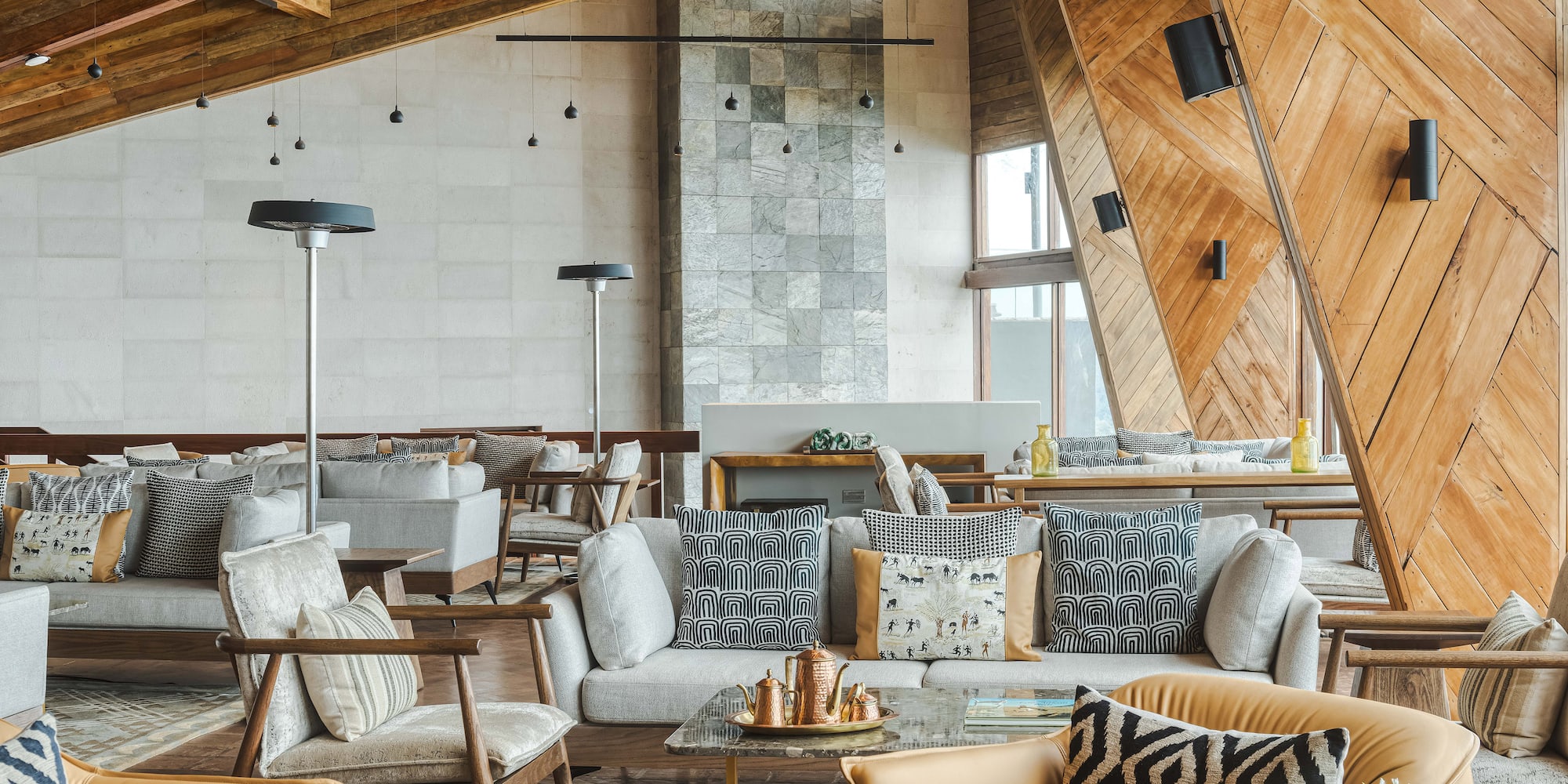 a room with a large couch and chairs