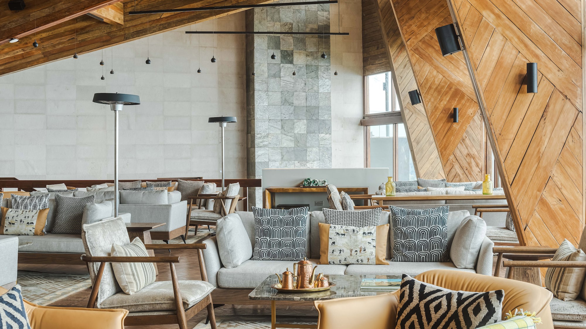 a room with a large couch and chairs