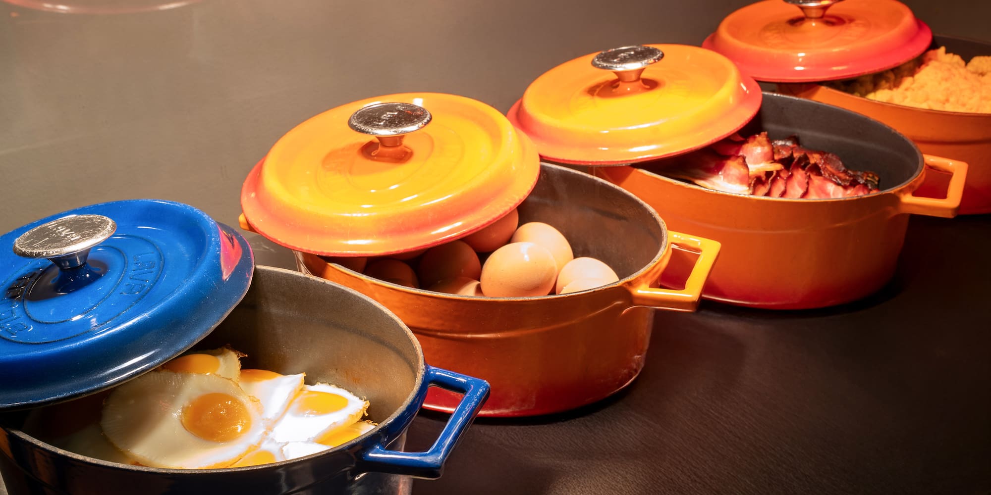 a group of pots with food in them