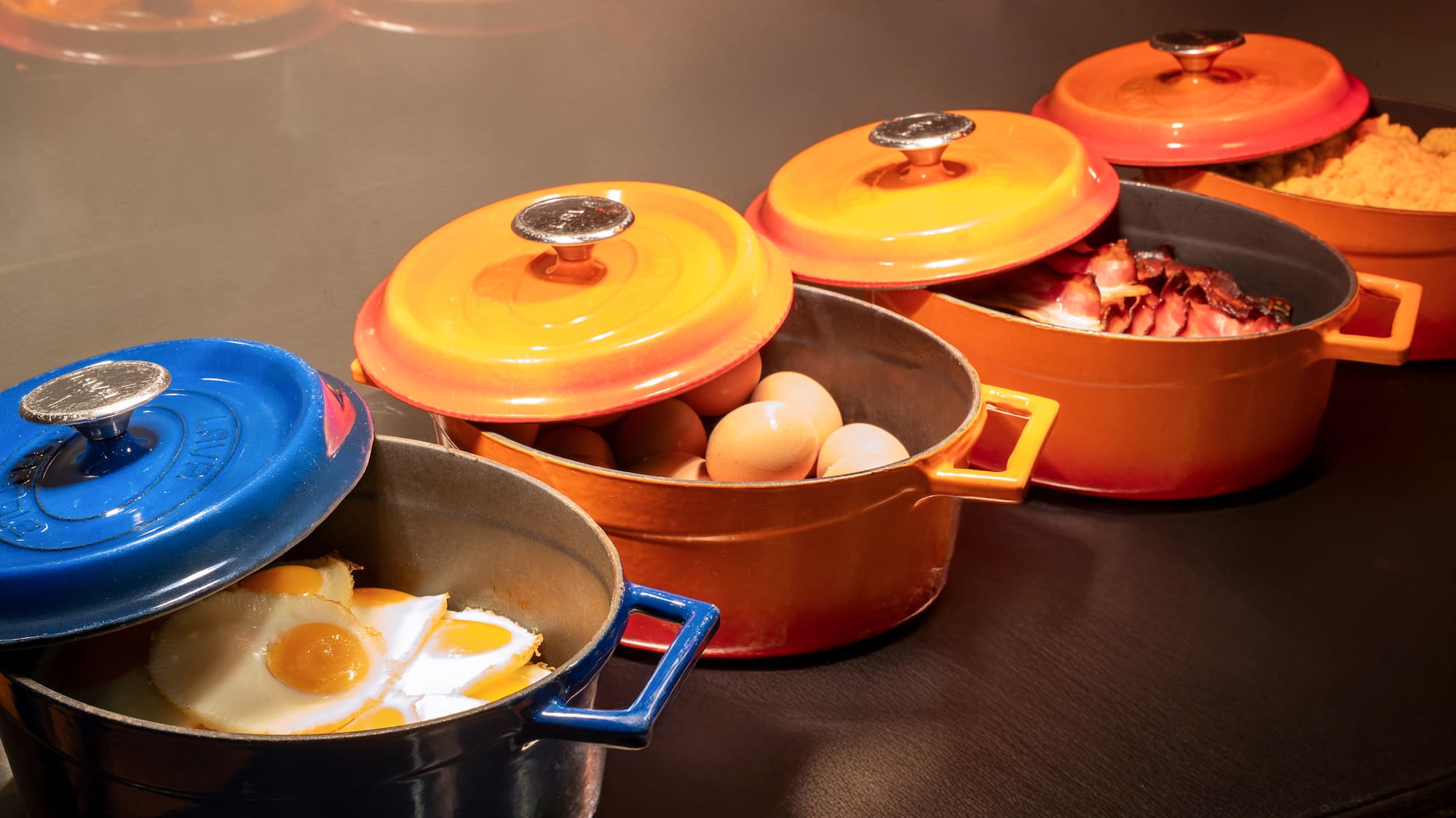 a group of pots with food in them