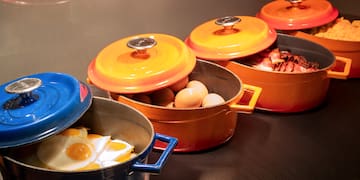 a group of pots with food in them