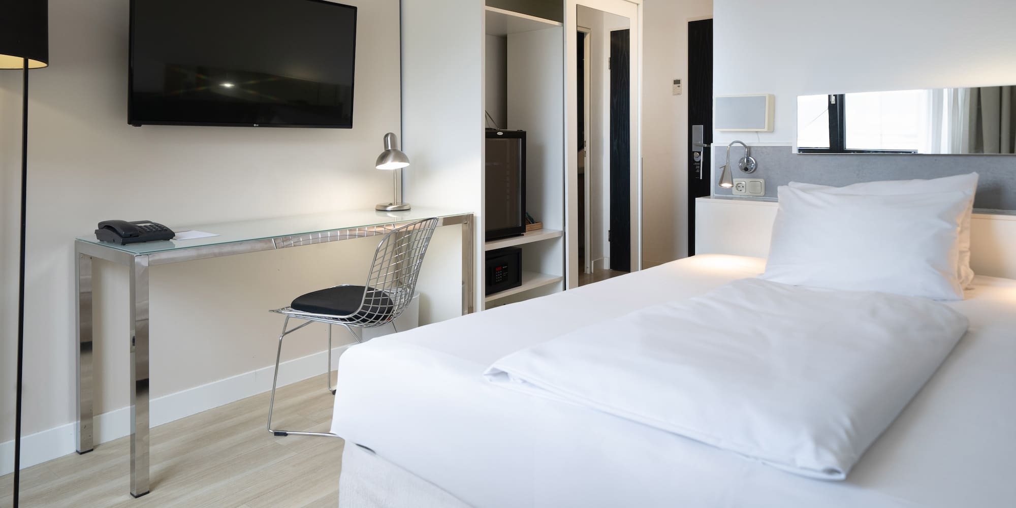 a room with a bed and a desk