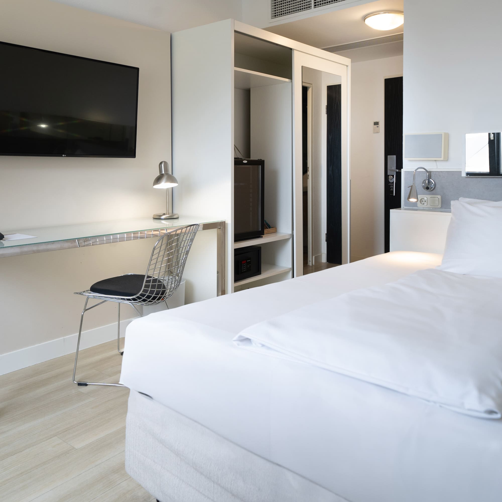 a room with a bed and a desk