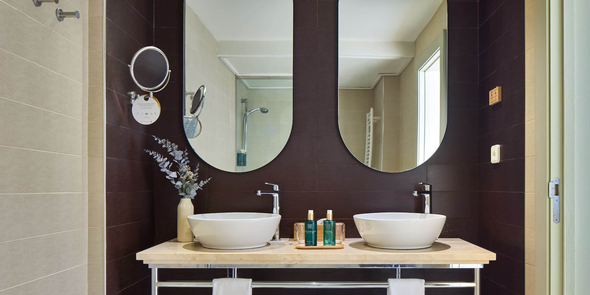 a bathroom with two sinks and mirrors