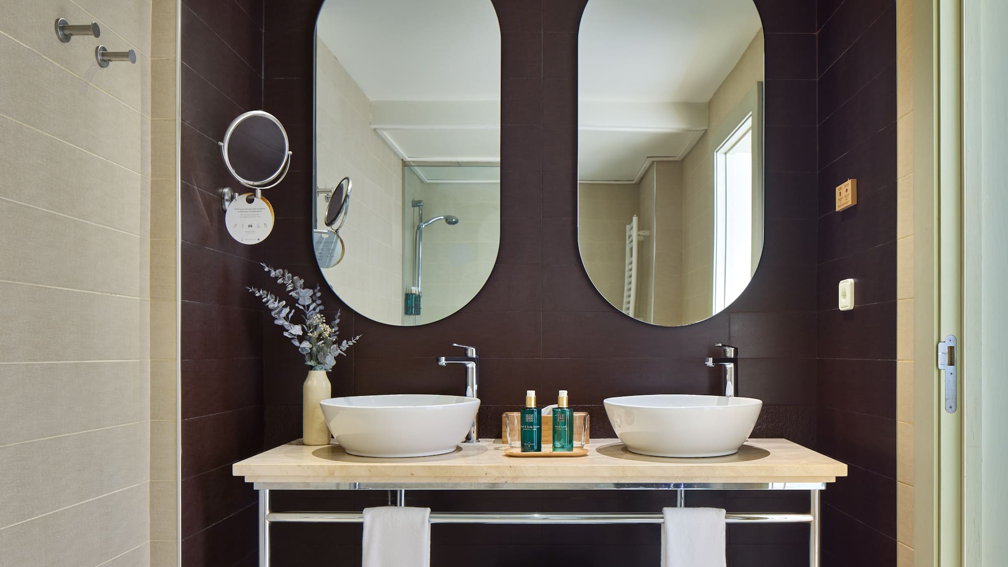 a bathroom with two sinks and mirrors