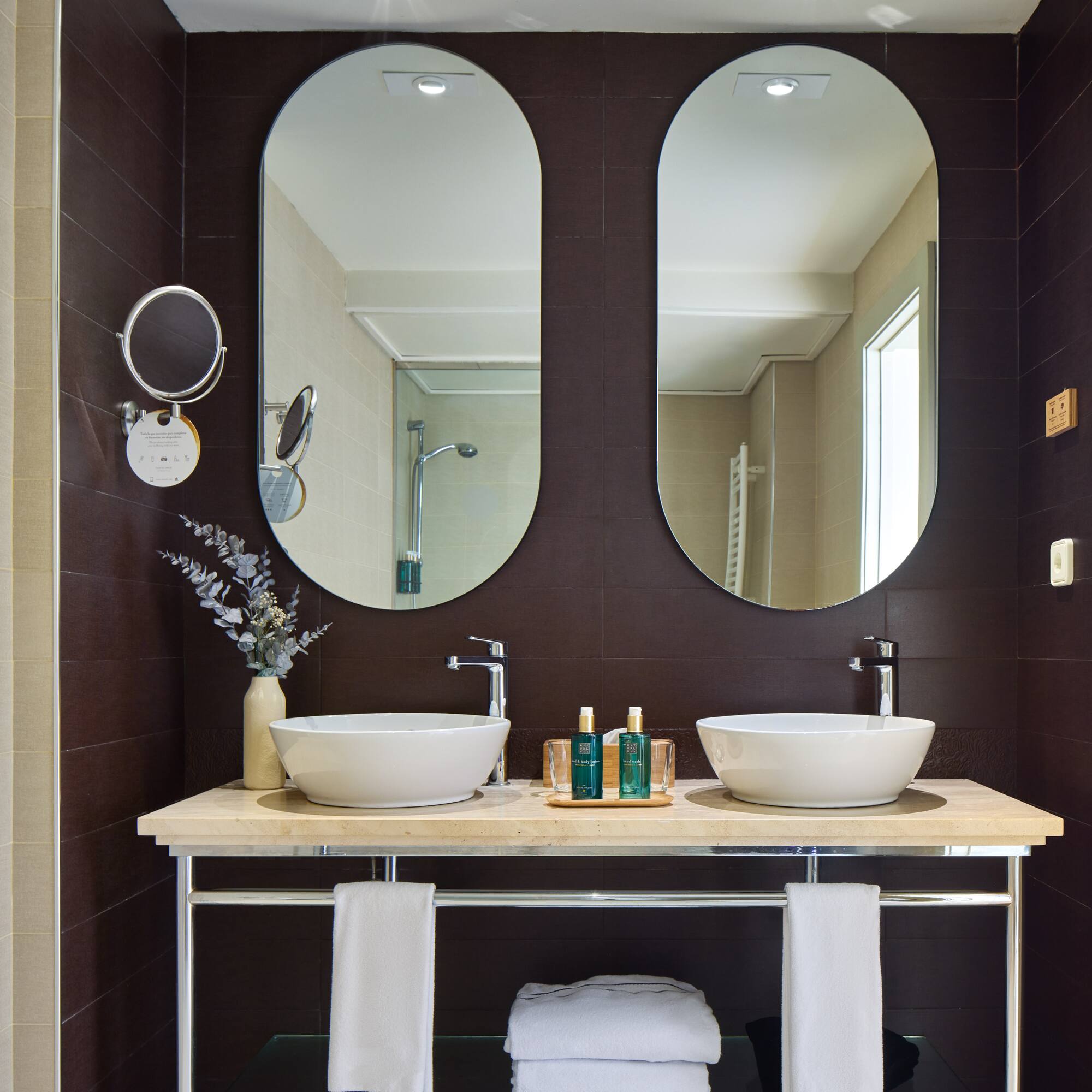 a bathroom with two sinks and mirrors