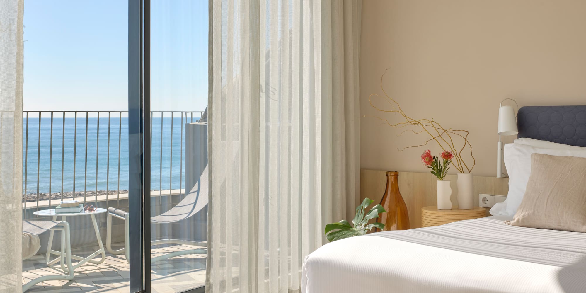 a room with a bed and a glass door