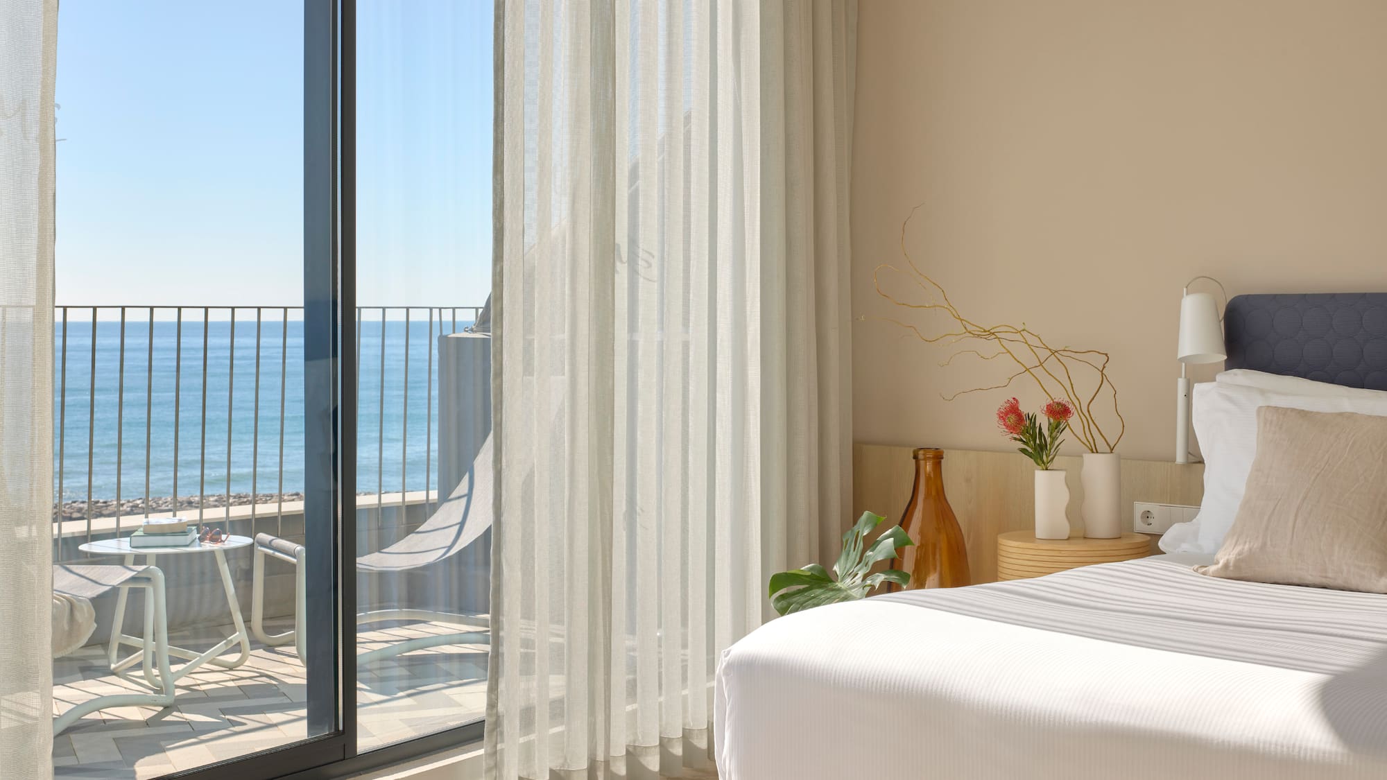 a room with a bed and a glass door