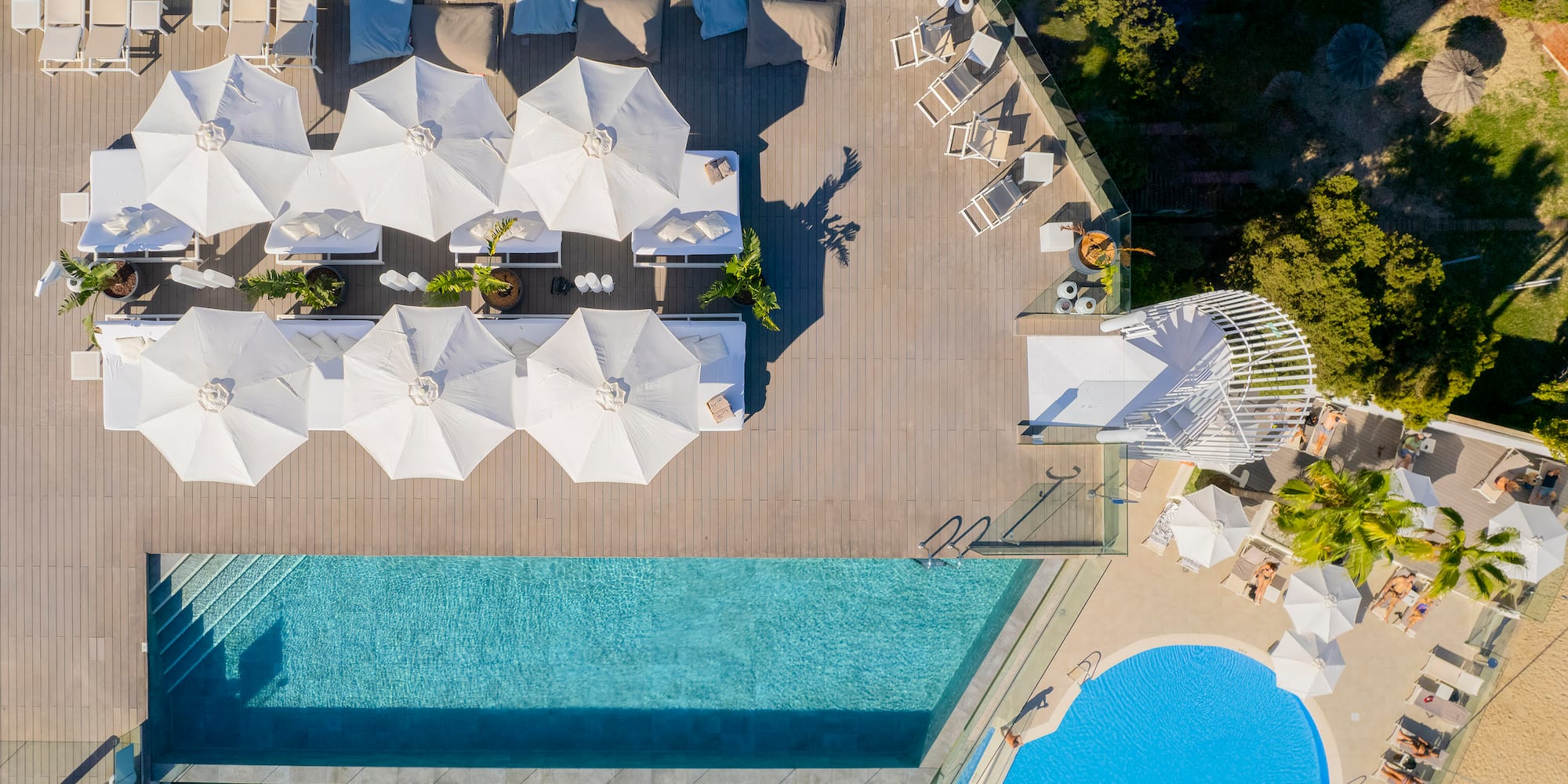 a pool with umbrellas and chairs