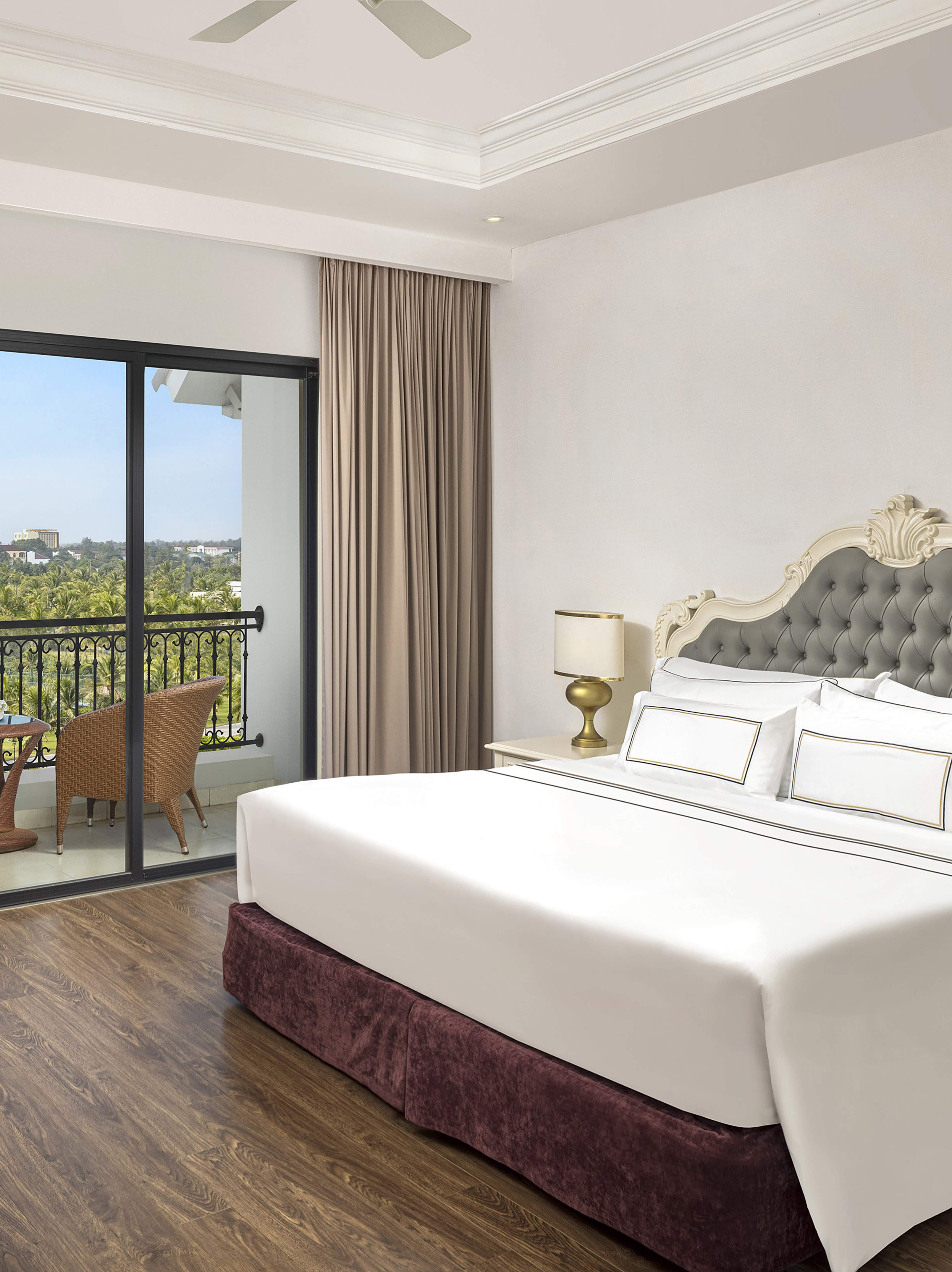 a bedroom with a glass door and a balcony