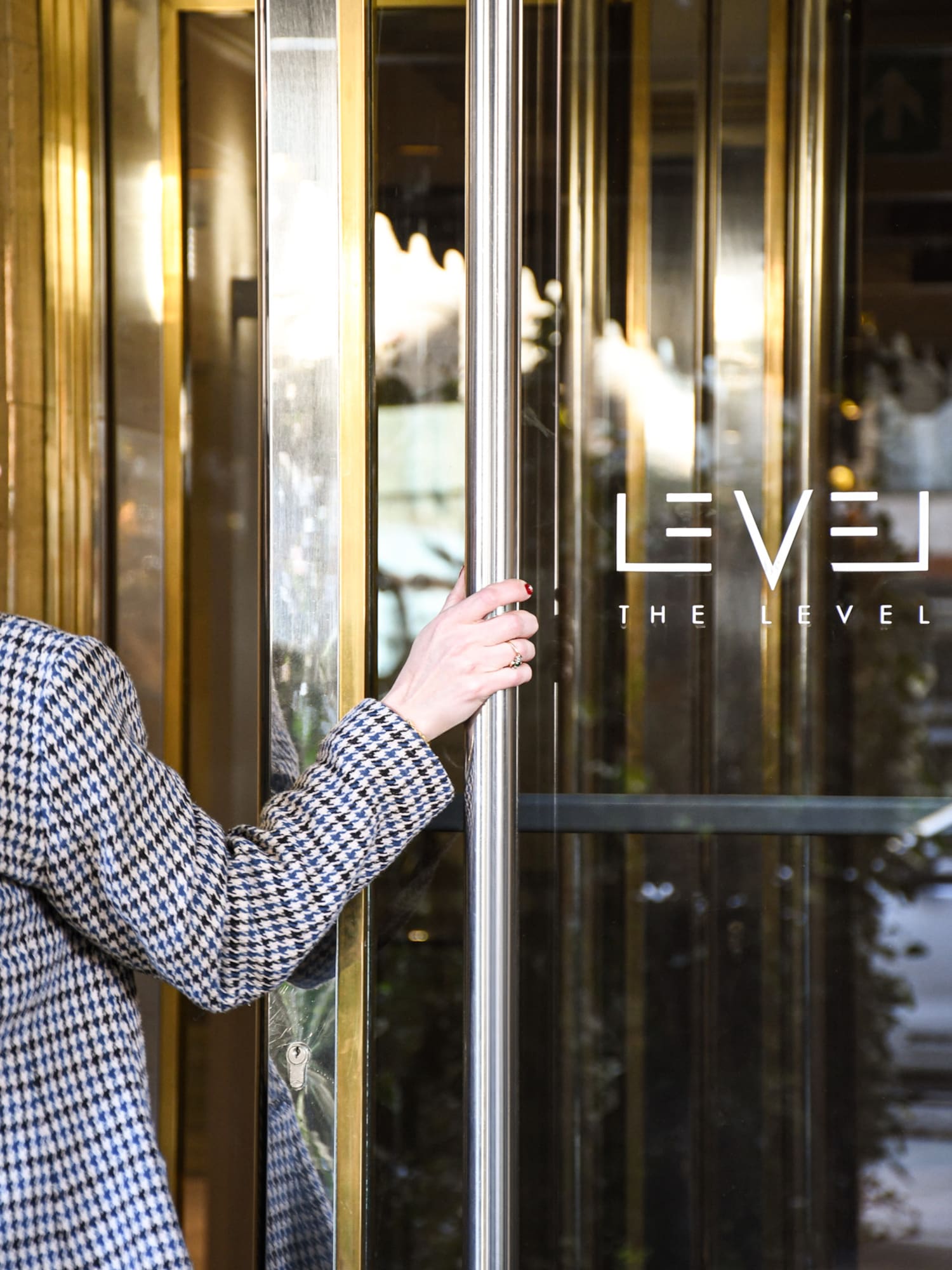 a person holding a glass door