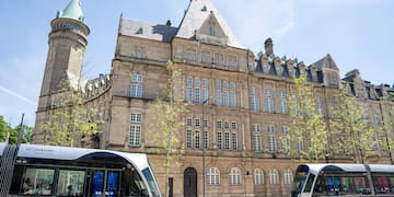 a two buses parked next to a building