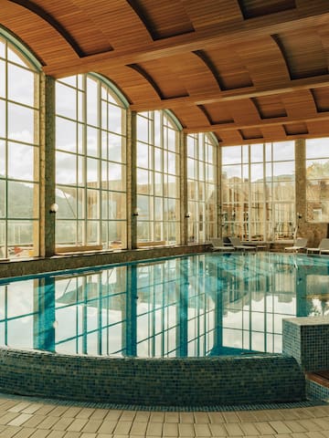 a large indoor pool with a large window