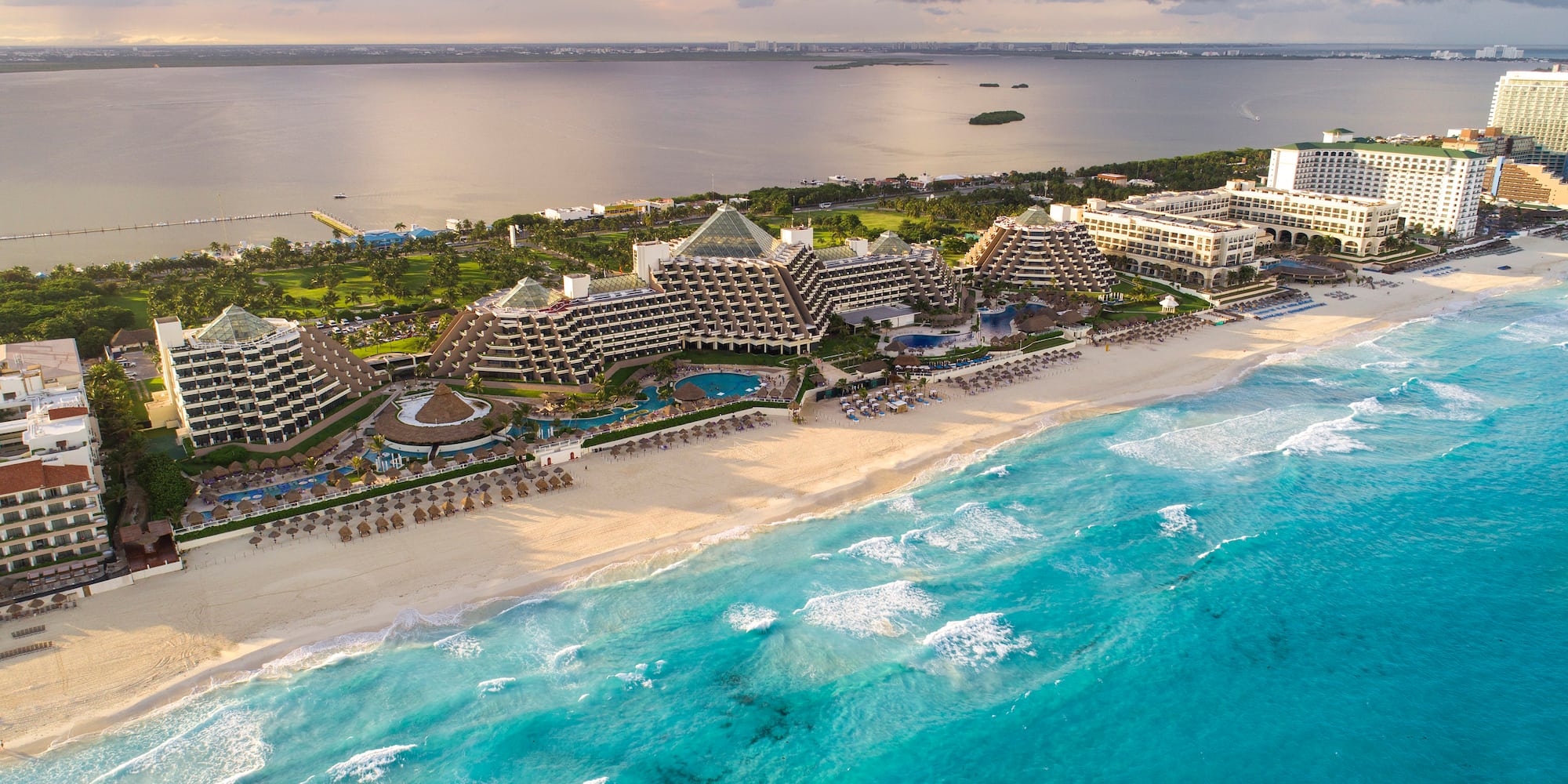 a beach with buildings and a body of water