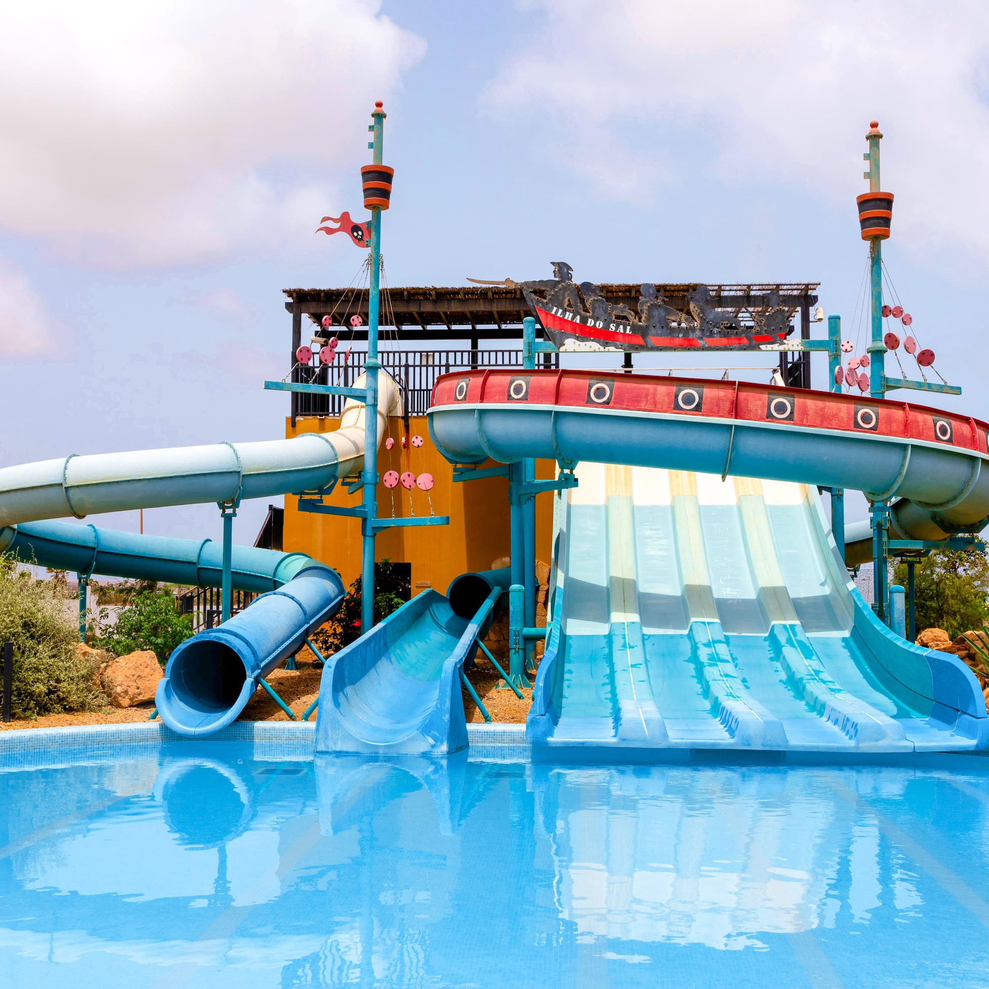 a water park with a pool and a slide
