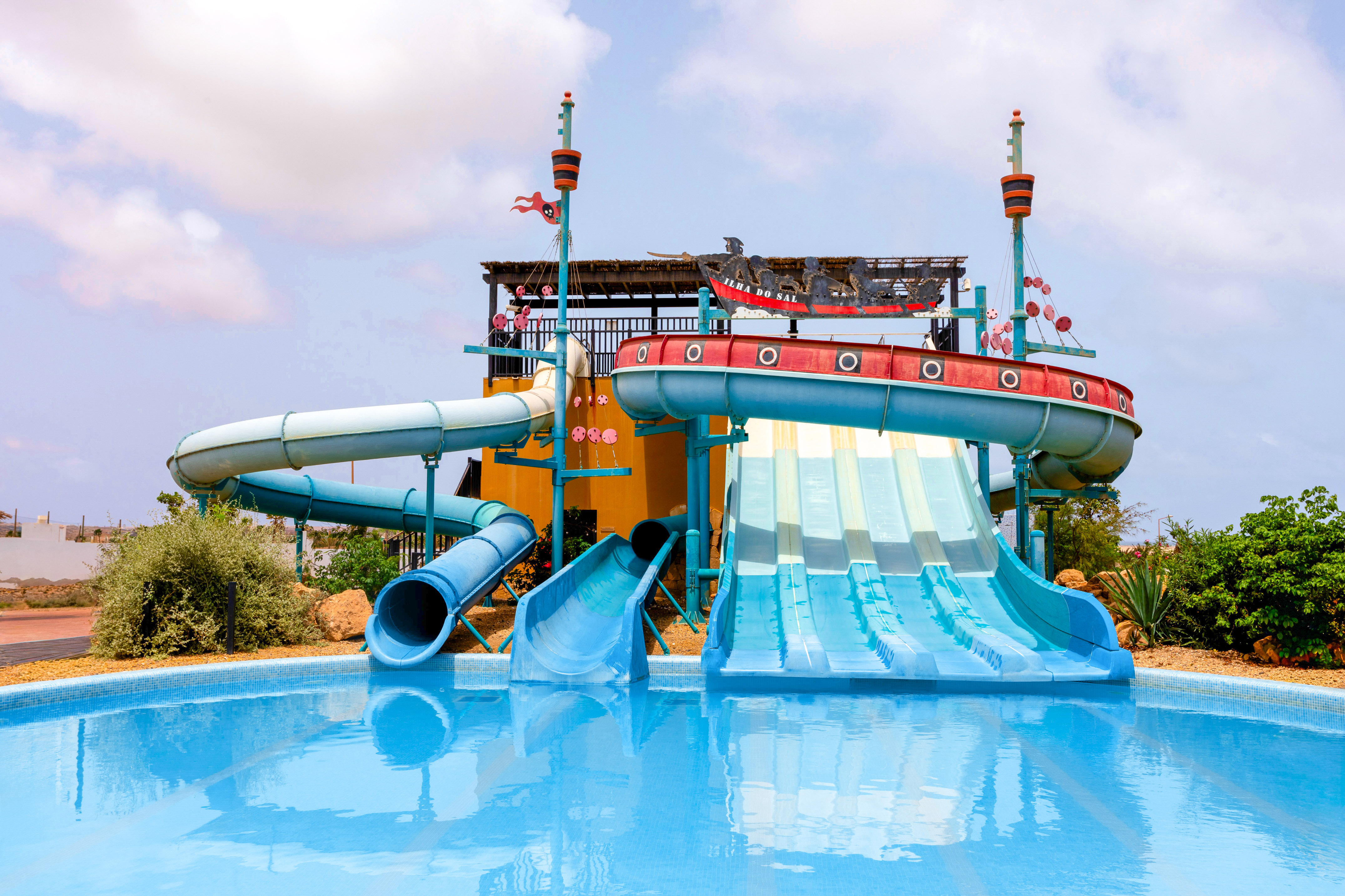 a water park with a pool and a slide
