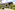Tropical YHI SPA entrance, modern building with lush landscaping and paved drive.