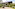 Tropical YHI SPA entrance, modern building with lush landscaping and paved drive.