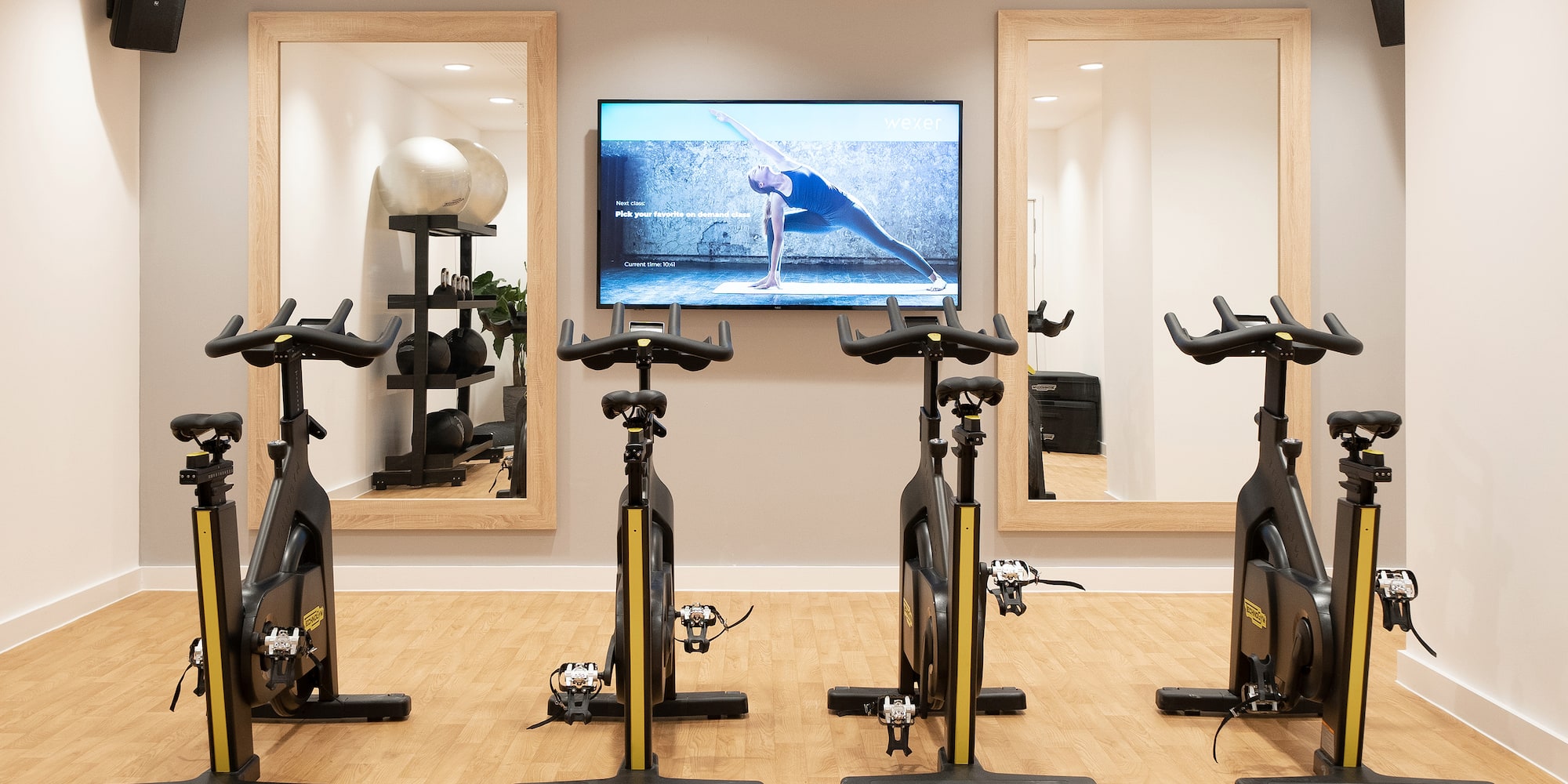 a room with exercise bikes and mirrors