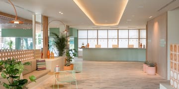 a lobby with a couch and chairs