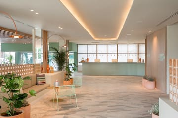 a lobby with a couch and chairs