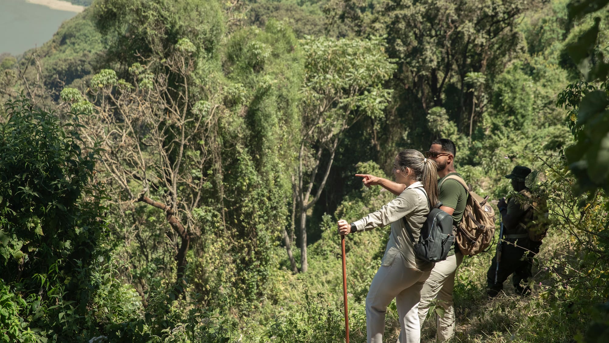 a man and woman hiking in the woods