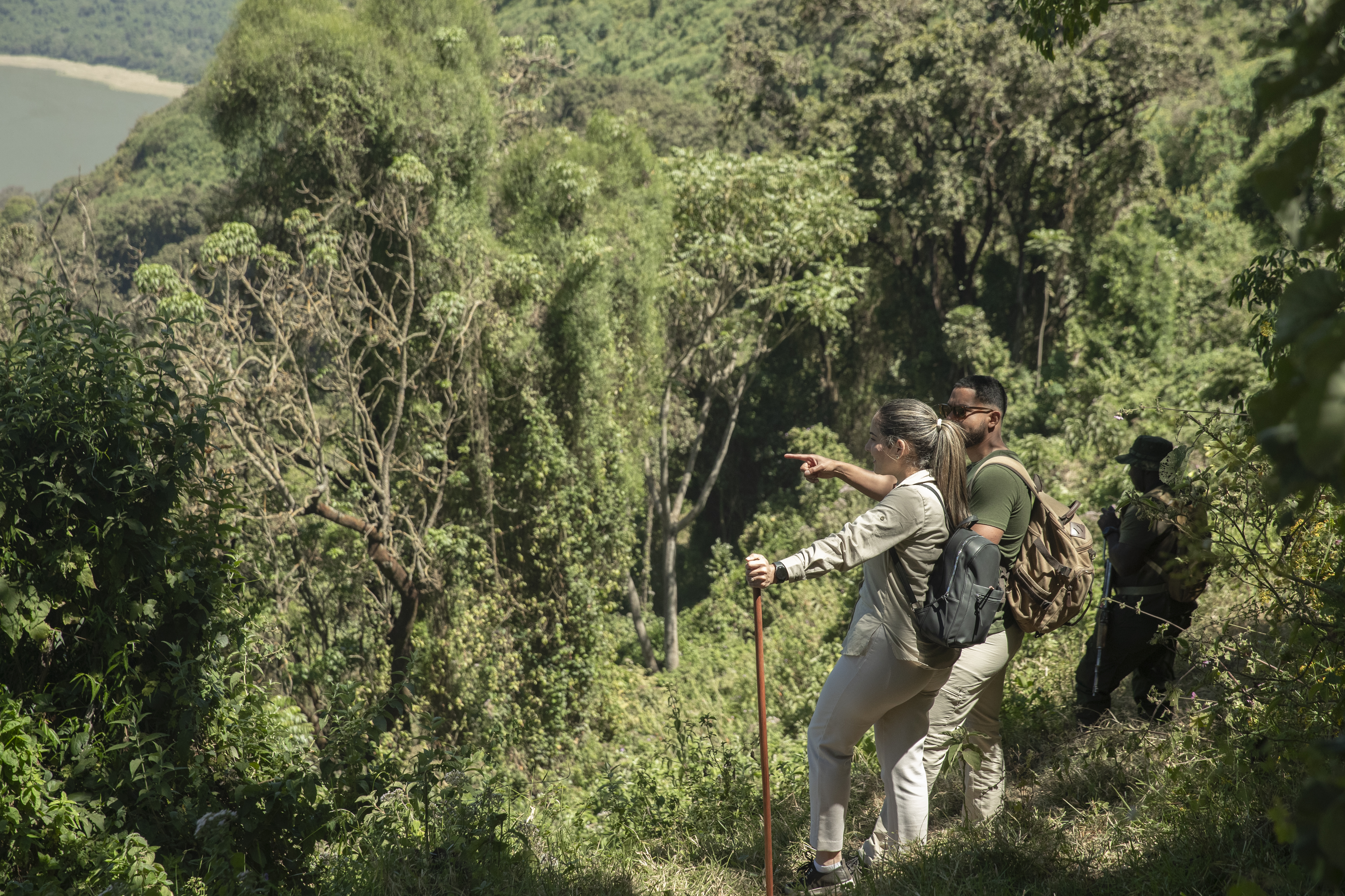 a man and woman hiking in the woods