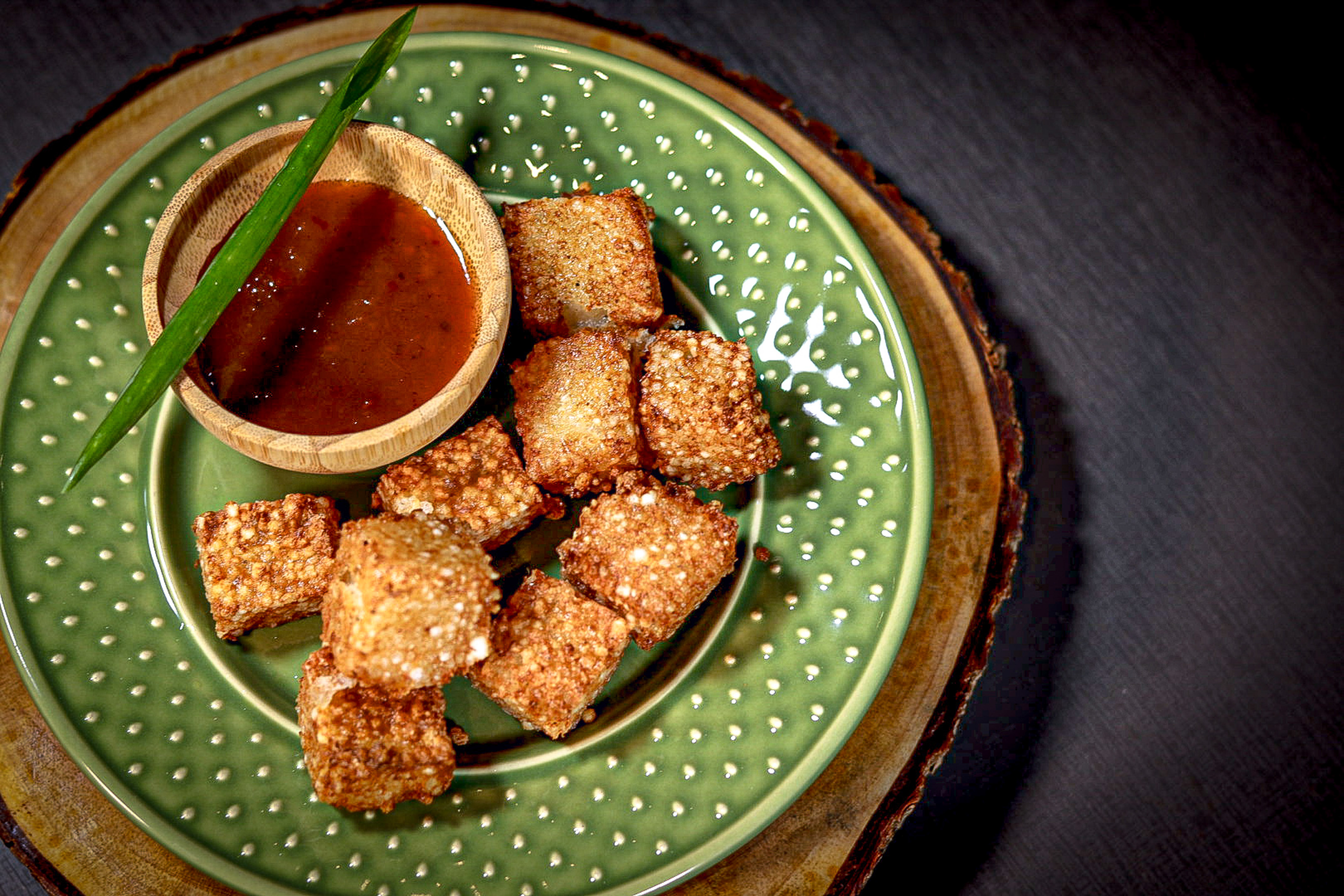 a plate of food with a bowl of sauce