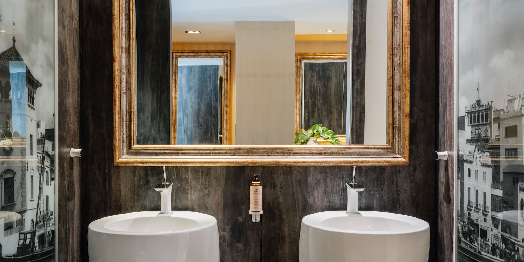 a bathroom with two sinks and a mirror