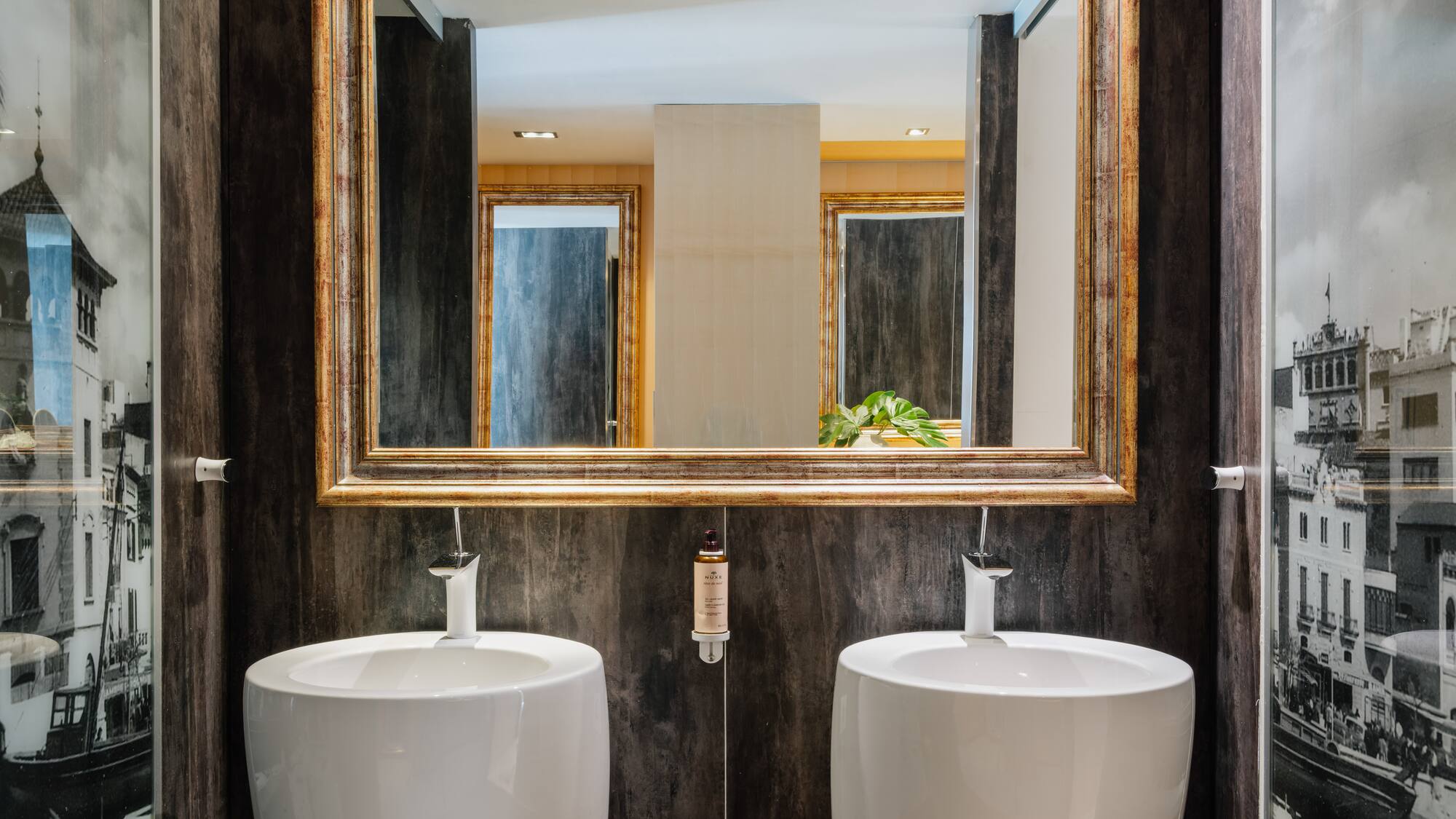 a bathroom with two sinks and a mirror